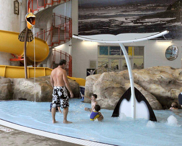 kids play at a Leisure Pool beside a waterslide in Sammamish City